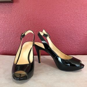 Black patent leather, platform, sling-back pumps.